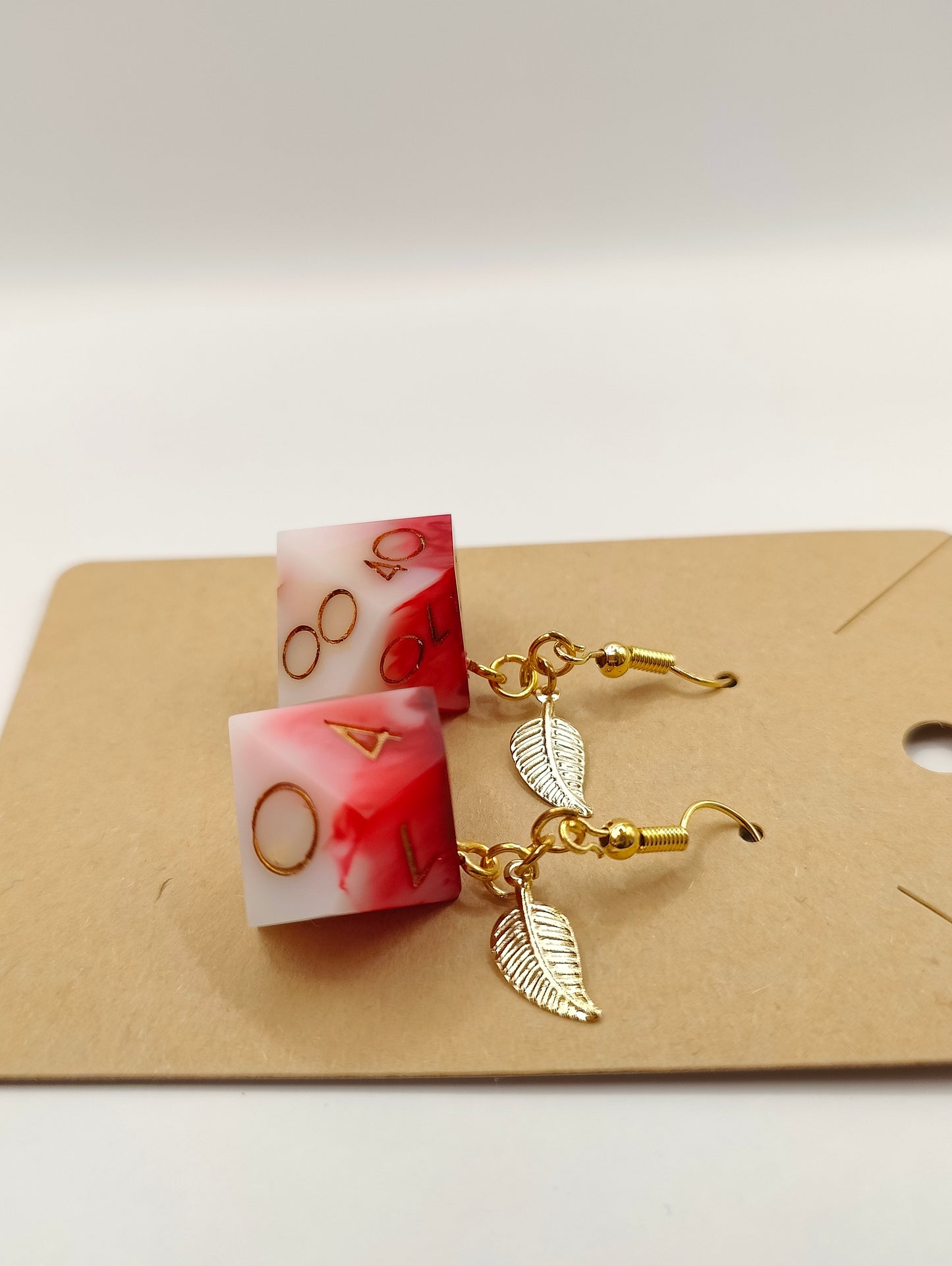 Handmade dangly D10/D% earrings: Inflict wounds